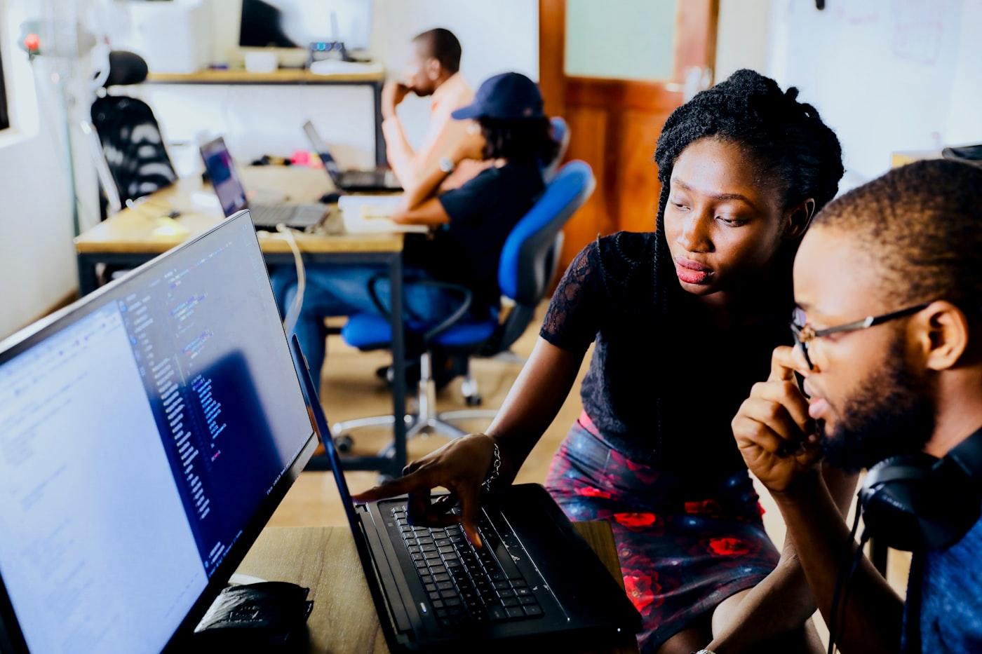 Engineers collaborating on code during an in-person technology training session